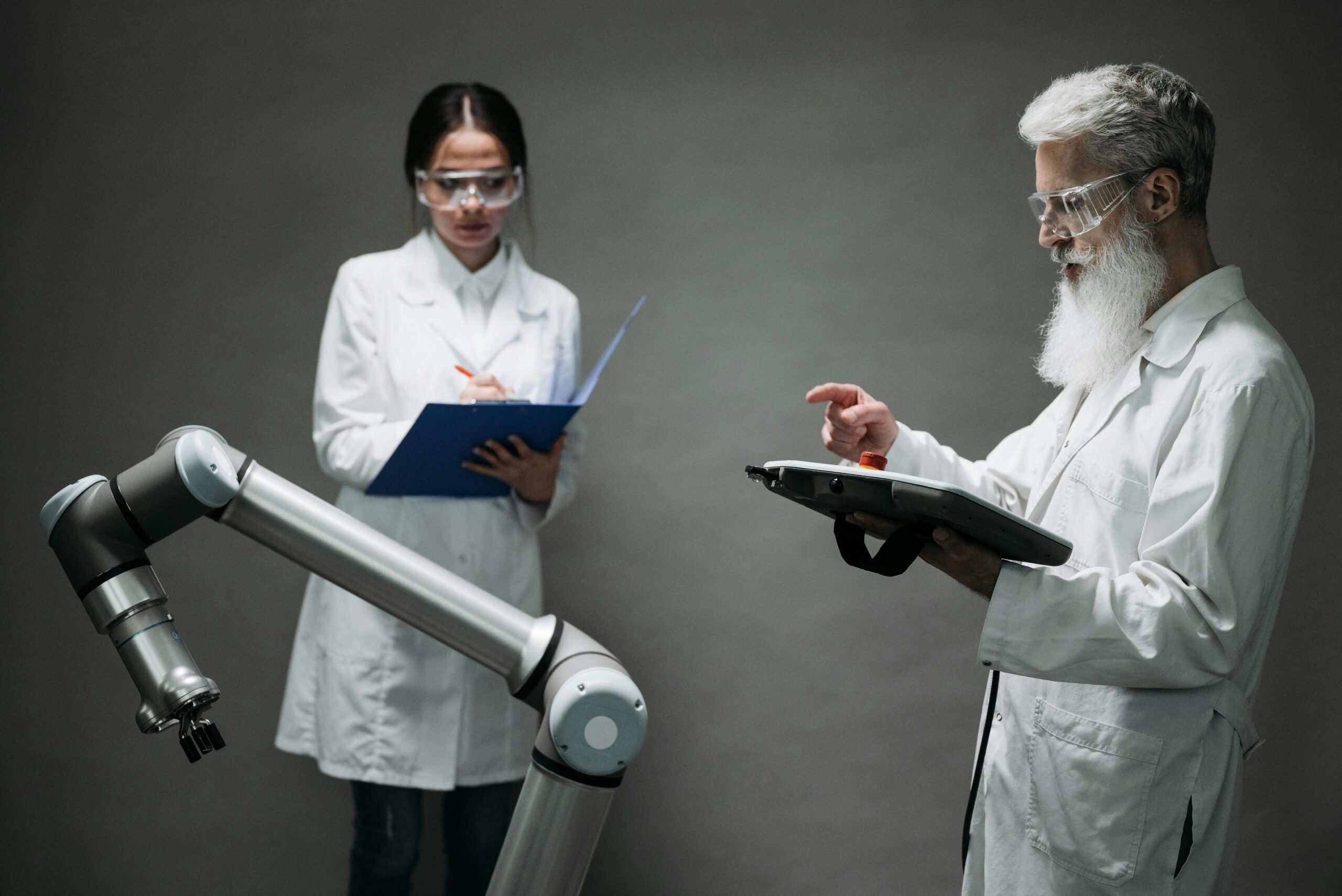 Scientists in a lab working with a robot, focusing on technological innovation and development.